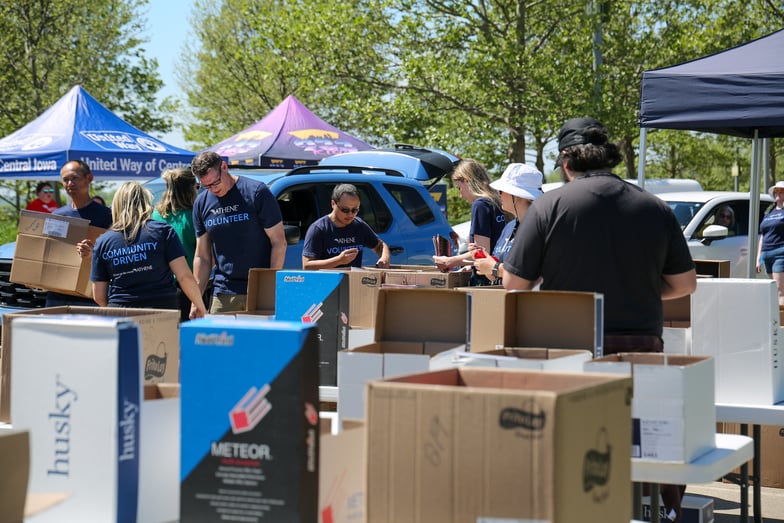 Volunteers unload and sort books at Stuff the Bus