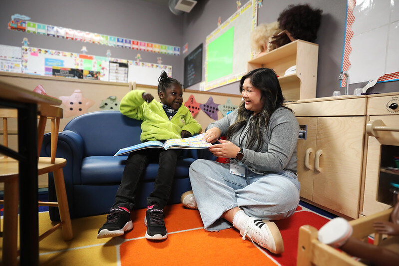Child and adult reading during a Book Buddy session.