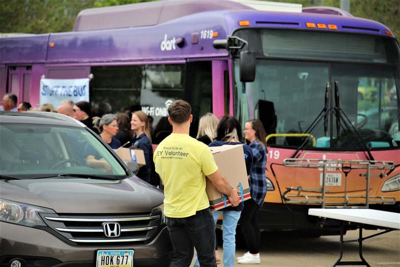 Volunteers load boxes of books at the annual Stuff the Bus event