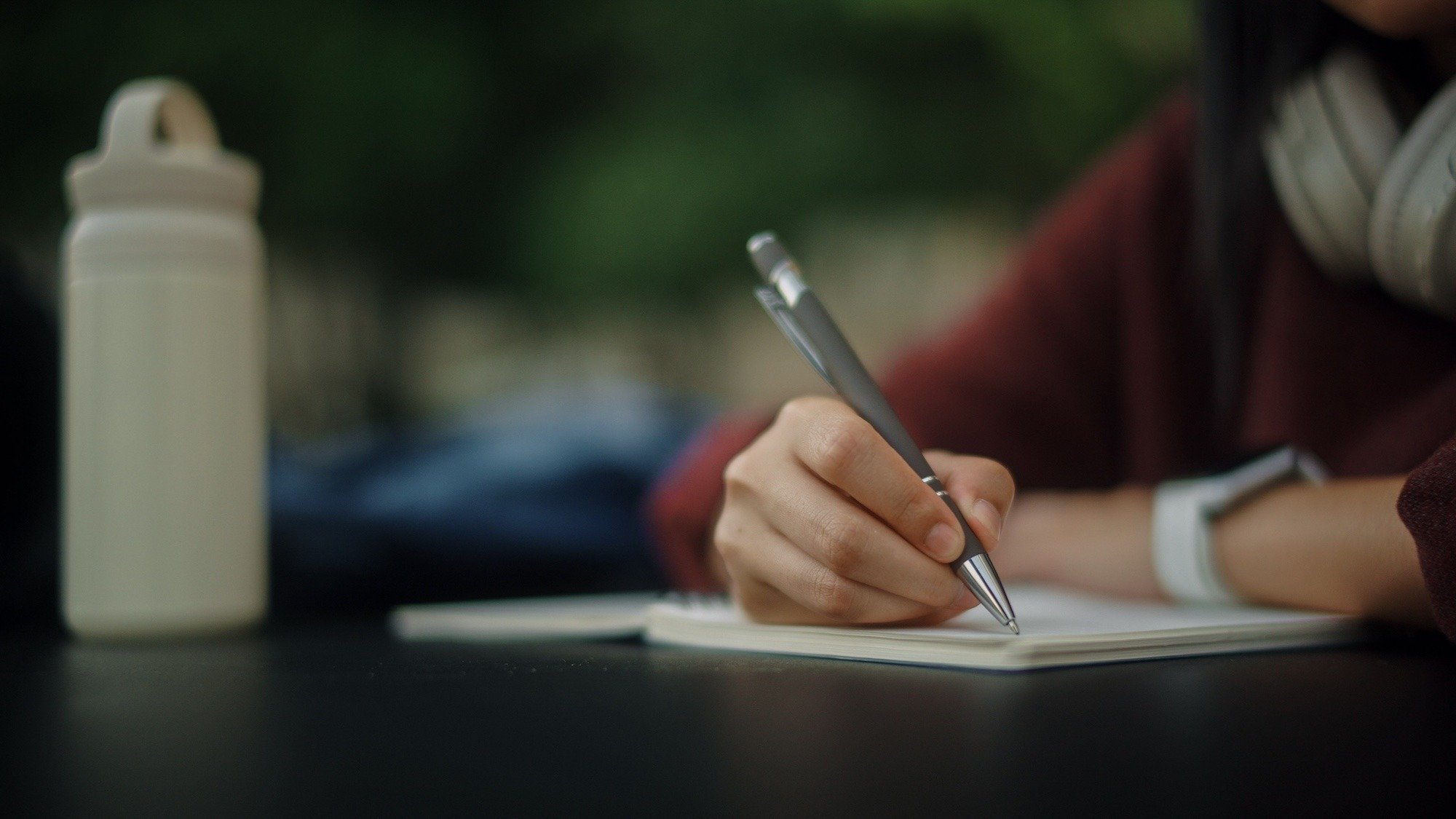 Individual writing a letter