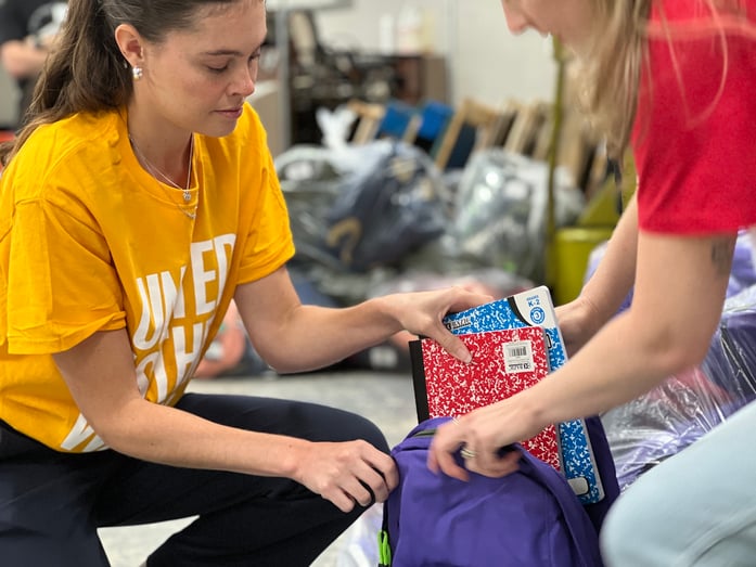 Volunteers building backpacks