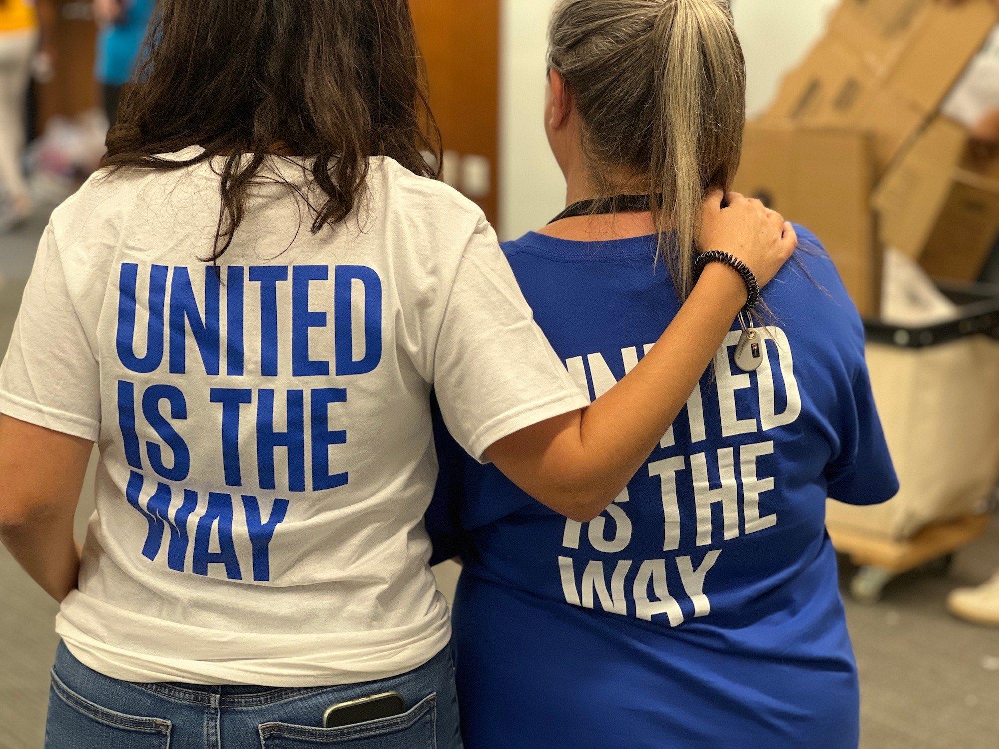 Volunteers Wearing United Is The Way Shirts